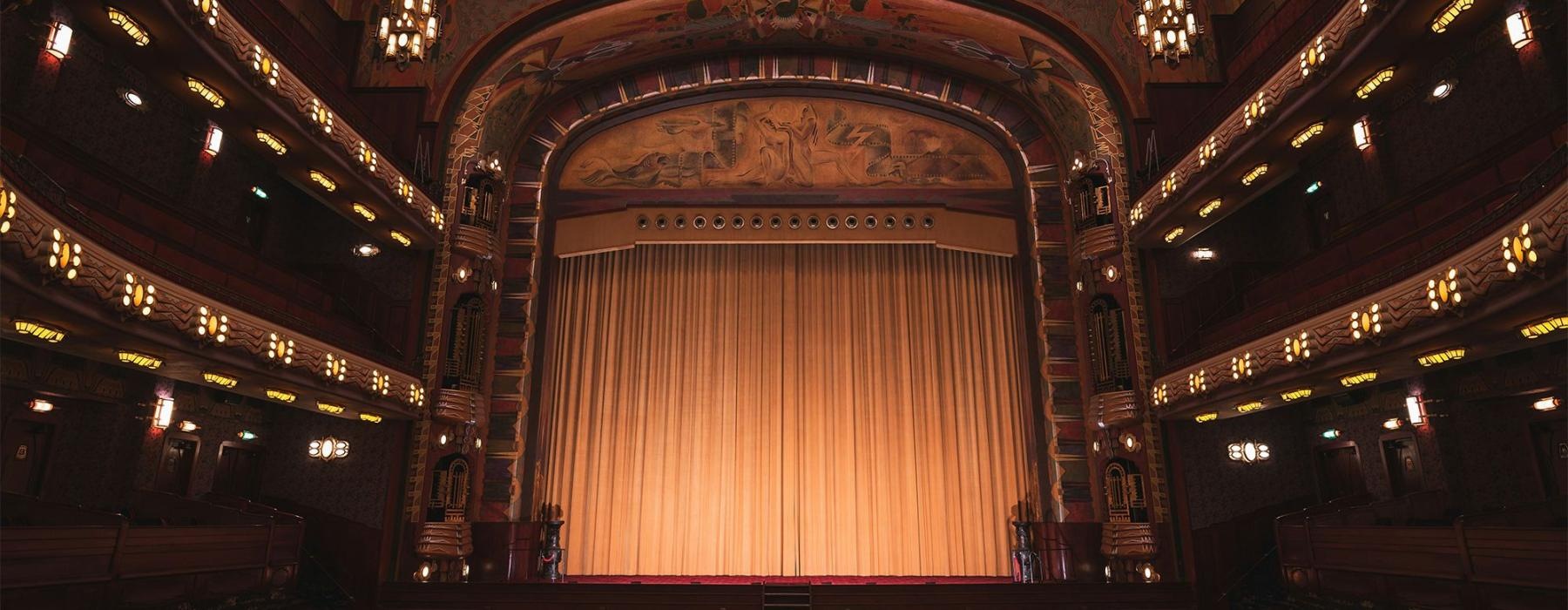 a theater with a stage and chairs