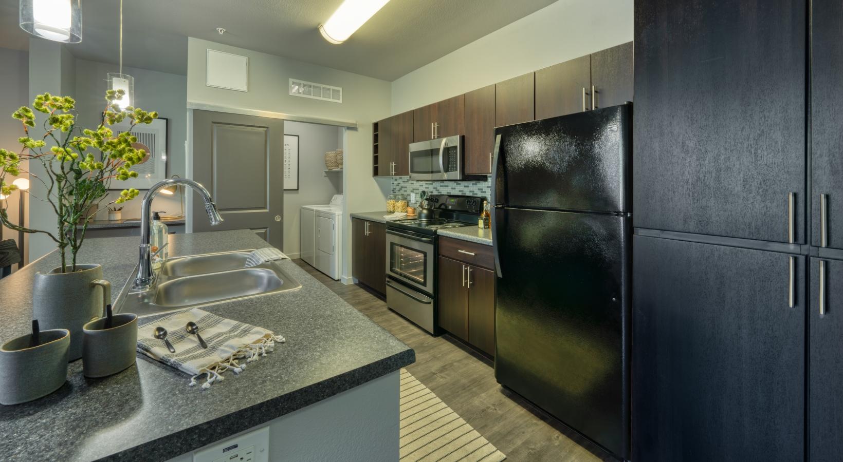 Spacious kitchens with thoughtful details a kitchen with black cabinets