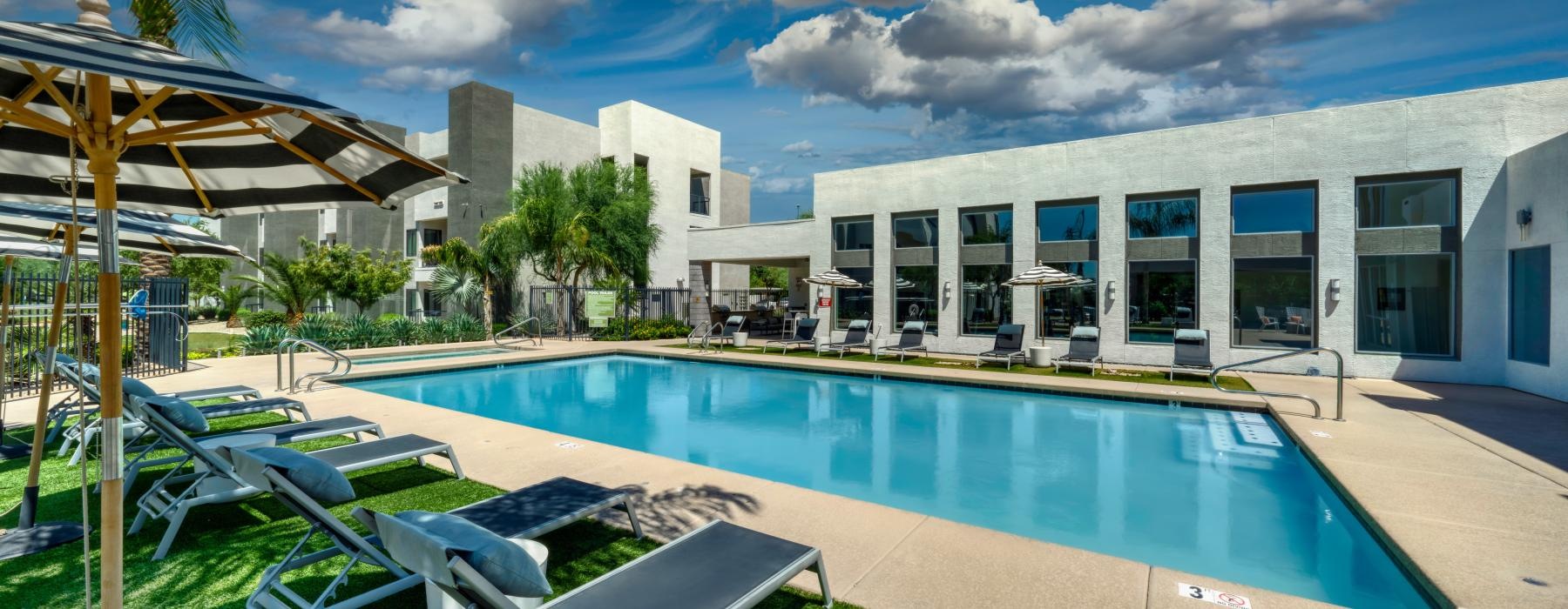 a swimming pool with chairs around it