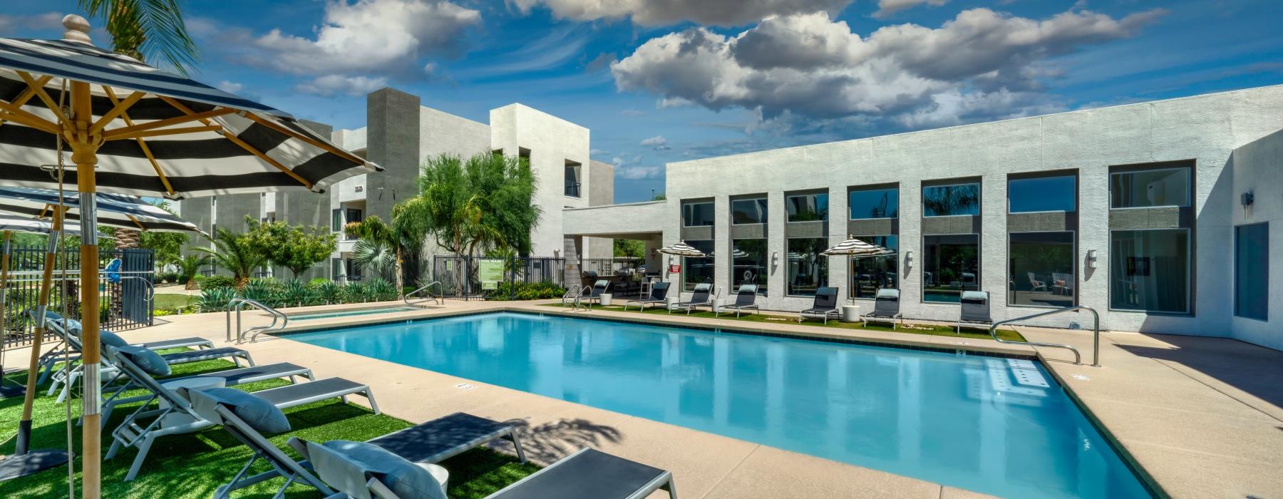 a swimming pool with chairs around it